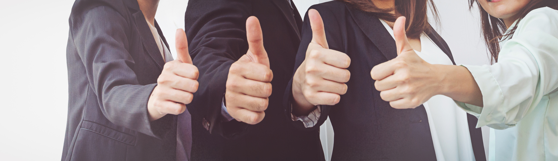 Successful business people with thumbs up, business team